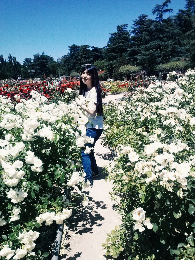 My friend, Maya, between white roses, her favorite.